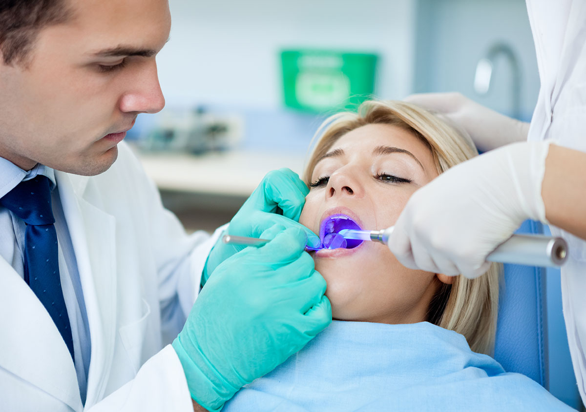 A woman is having laser dentistry treatment