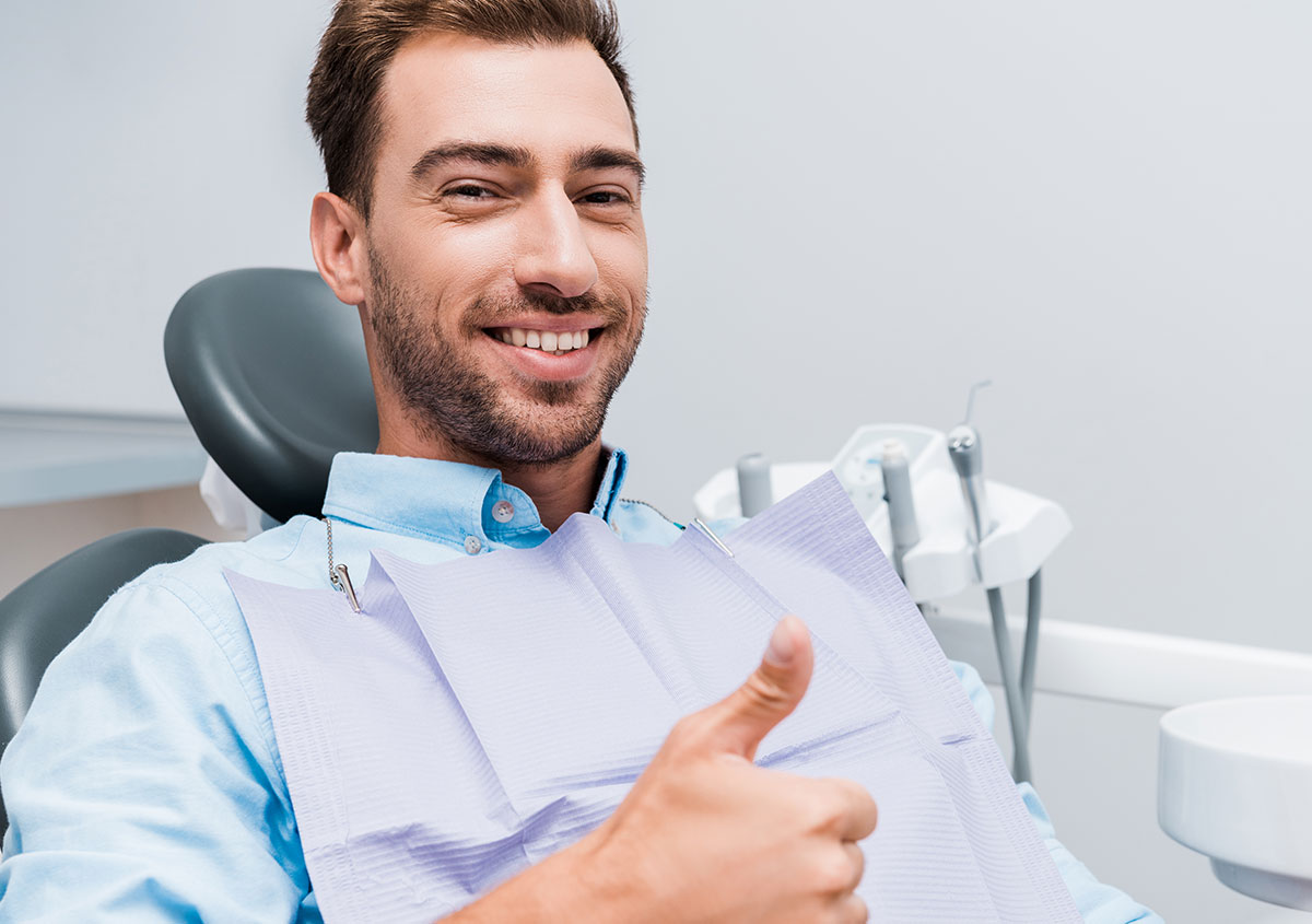 A man is smiling at dental clinic