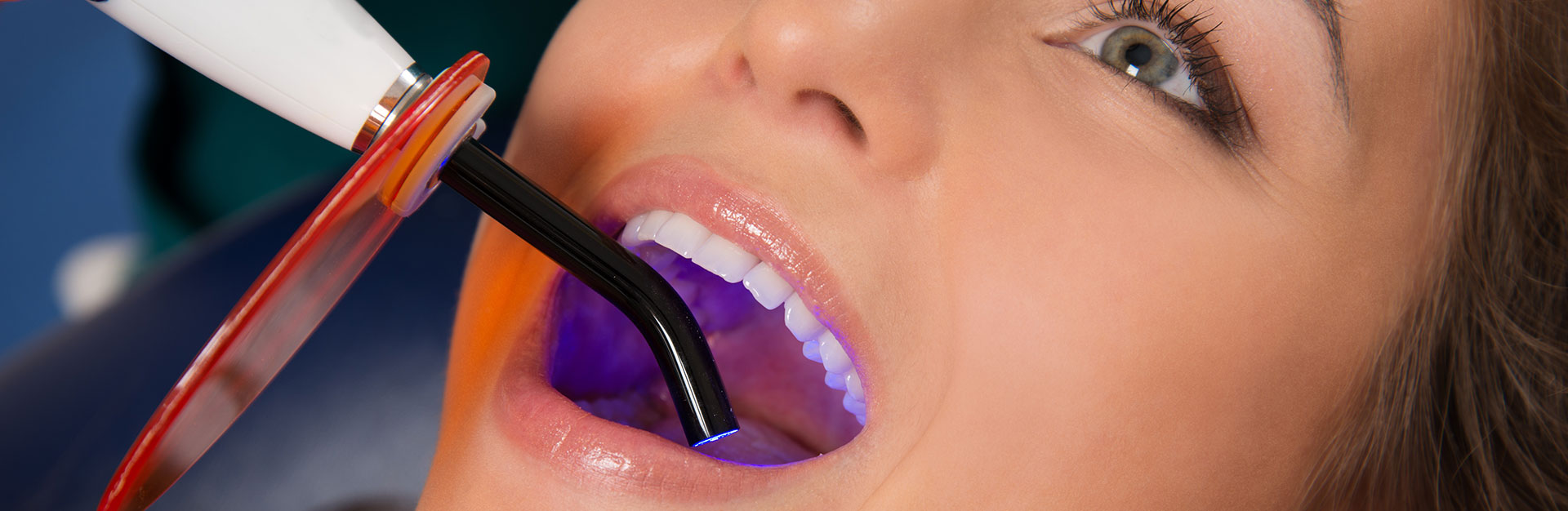 A woman is having laser dental treatment